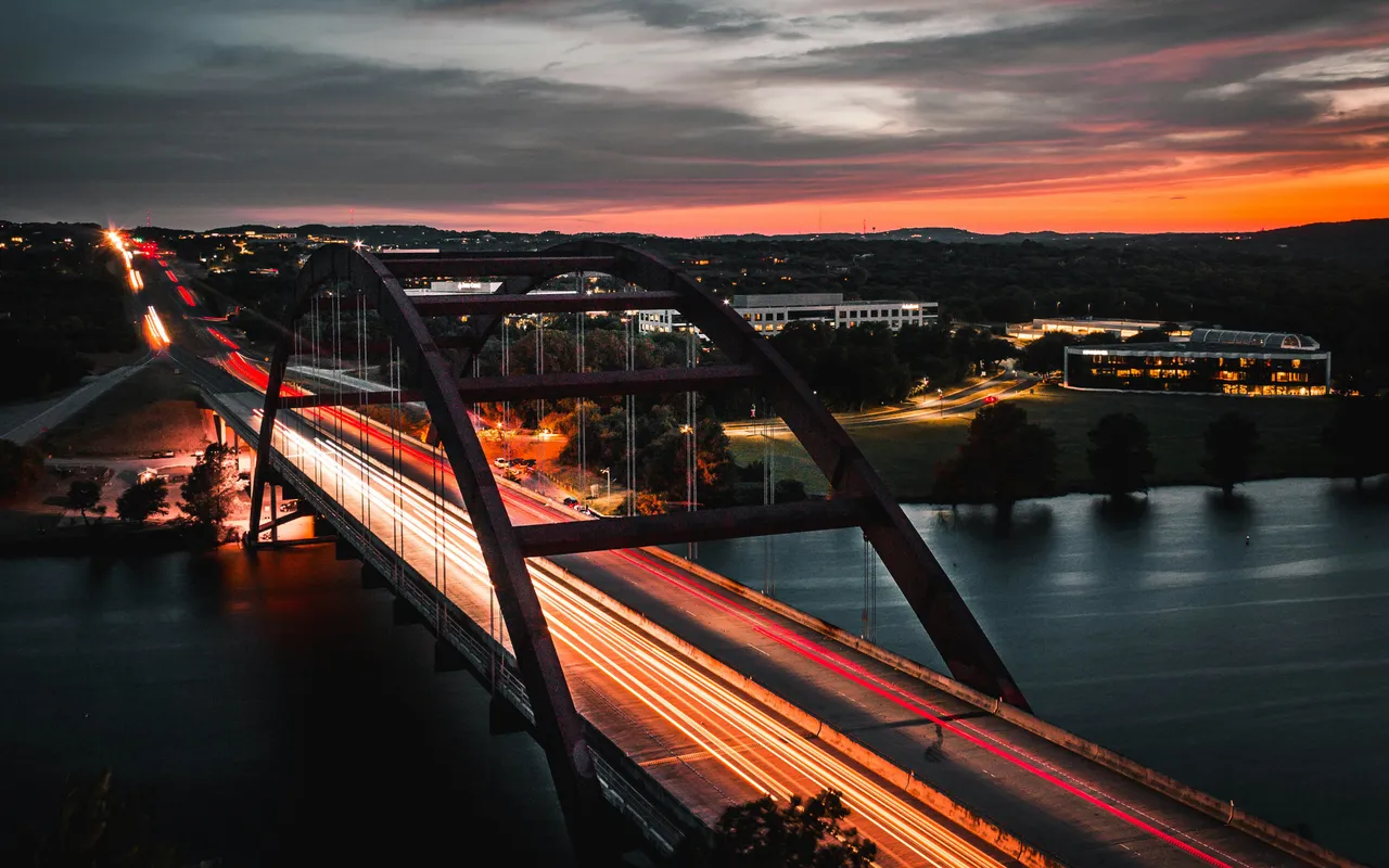 Austin's Pennybacker Bridge at sunset: Fast-loading websites stream traffic like light trails below.