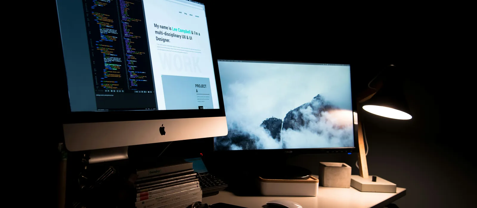 Two computer monitors displaying code and website design, emphasizing custom web development services.